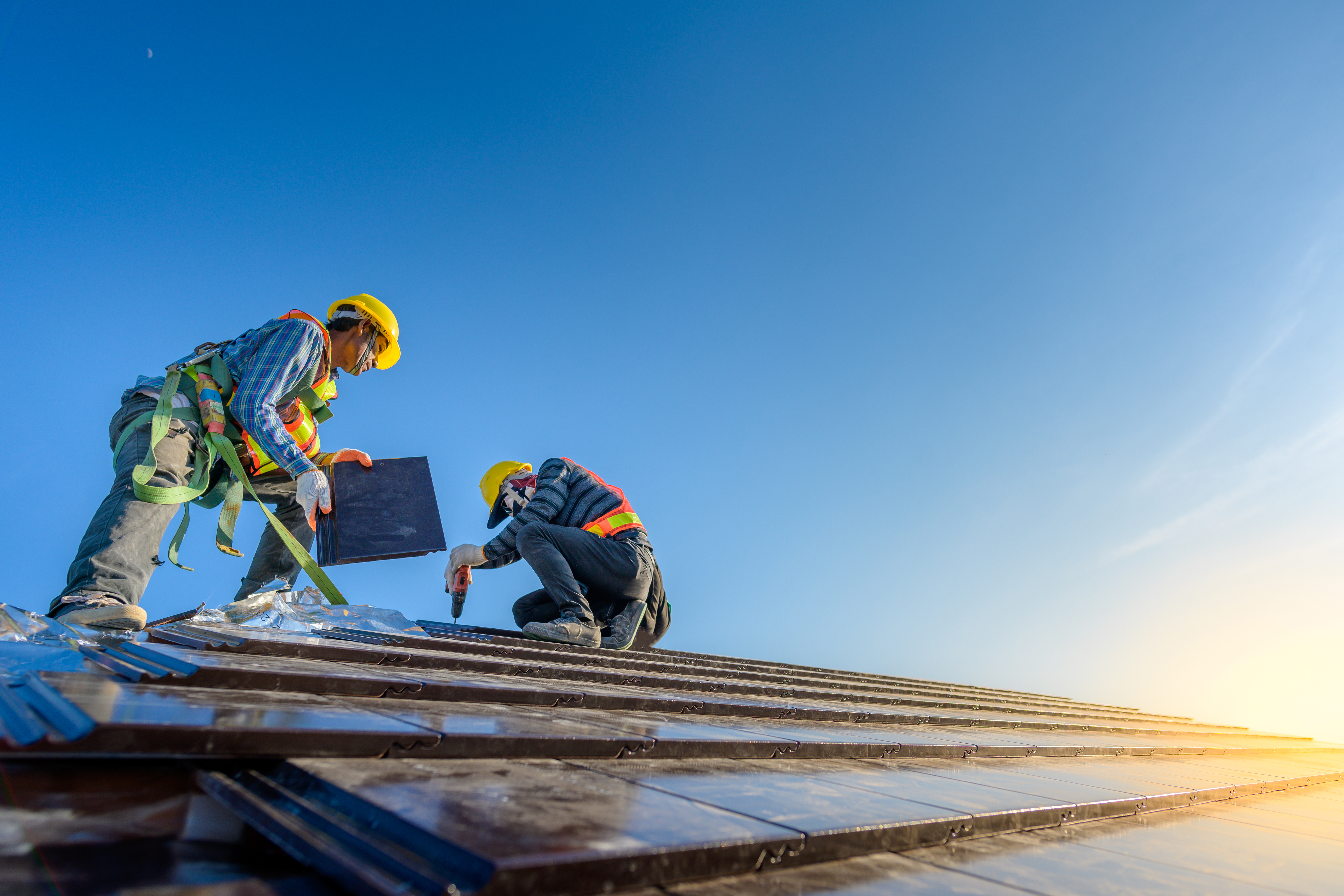 two construction workers on a roof