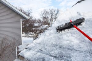 Broom to brush snow off to prevent damage to roof and ice dams