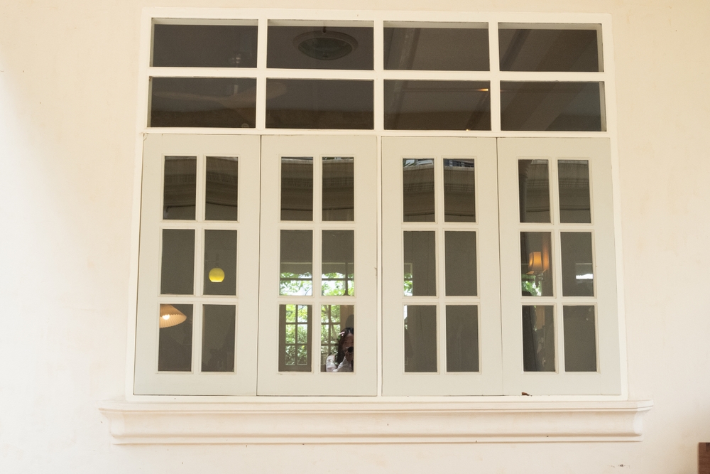 Cozy house exterior with wooden casement windows
